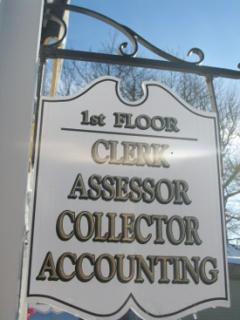 Wooden sign with words "1st Floor: Assessor, Collector, Accounting"
